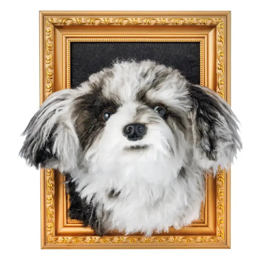 Custom framed plush pet portrait featuring a fluffy black and white dog head mounted in a golden decorative frame.